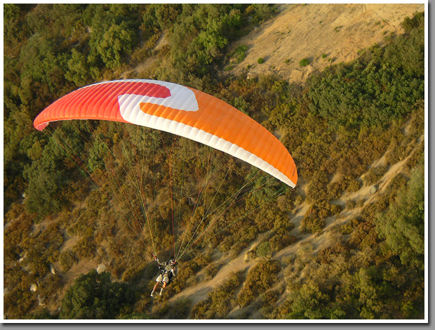Parglider pilot flying his wing at Vizcachas site in Cajon del Maipo near Santiago, Chile
