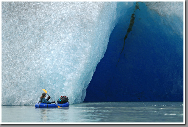 KSZ paddling her packraft into an ice cave created by melting ice of Glacier Steffen - Southernmost glacier of Northern Patagonian Ice Field, Aisen, Patagonia, Chile