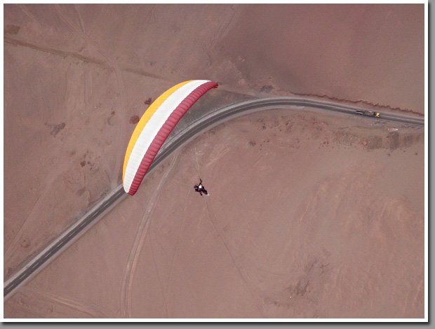 Tandem paraglider piloted by Philip Maltry with his daughter over Patillos take-off, Iquique, The Atacama Desert, Chile